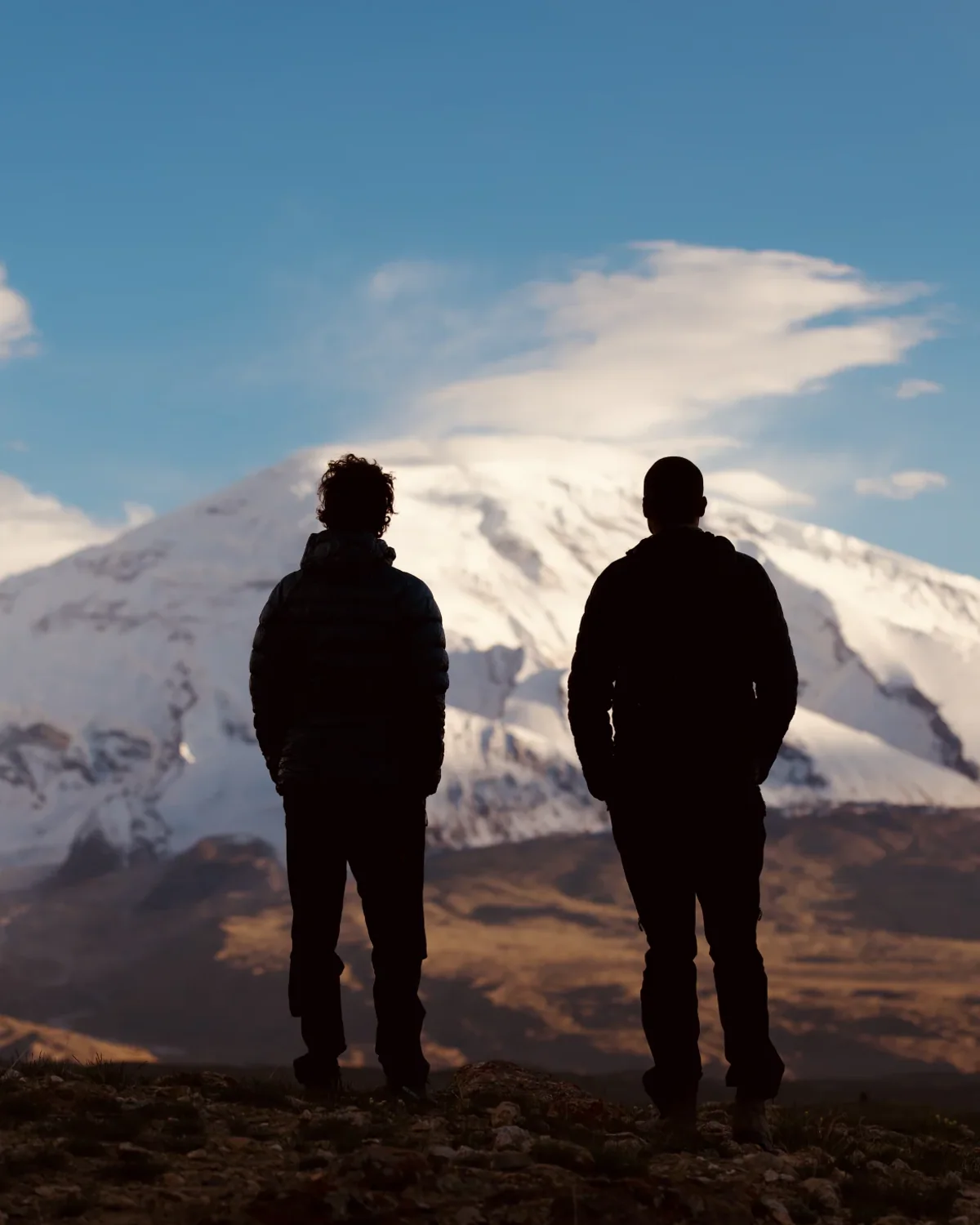 Two expedition team members watching Muztagh Ata